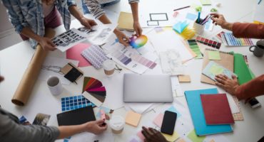 Creative Designer Team Discussing Production over Table